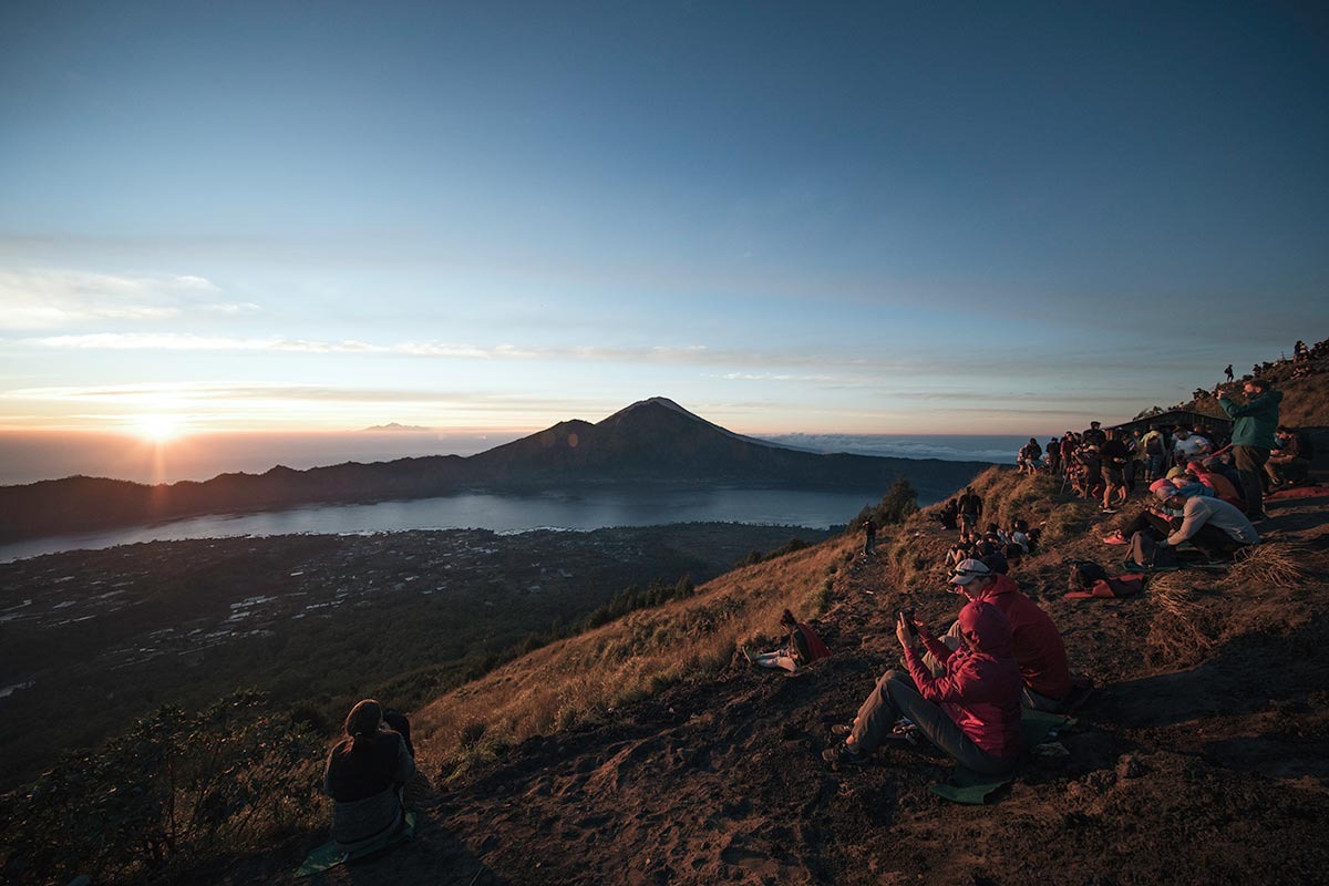 Travelers enjoying breakfast while watching sunrise at Mount Batur.