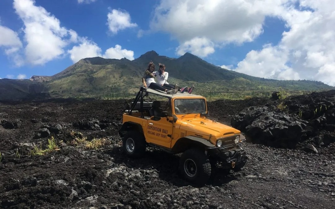 Black Lava fields at Mount Batur explored by jeep during sunrise adventure tour.