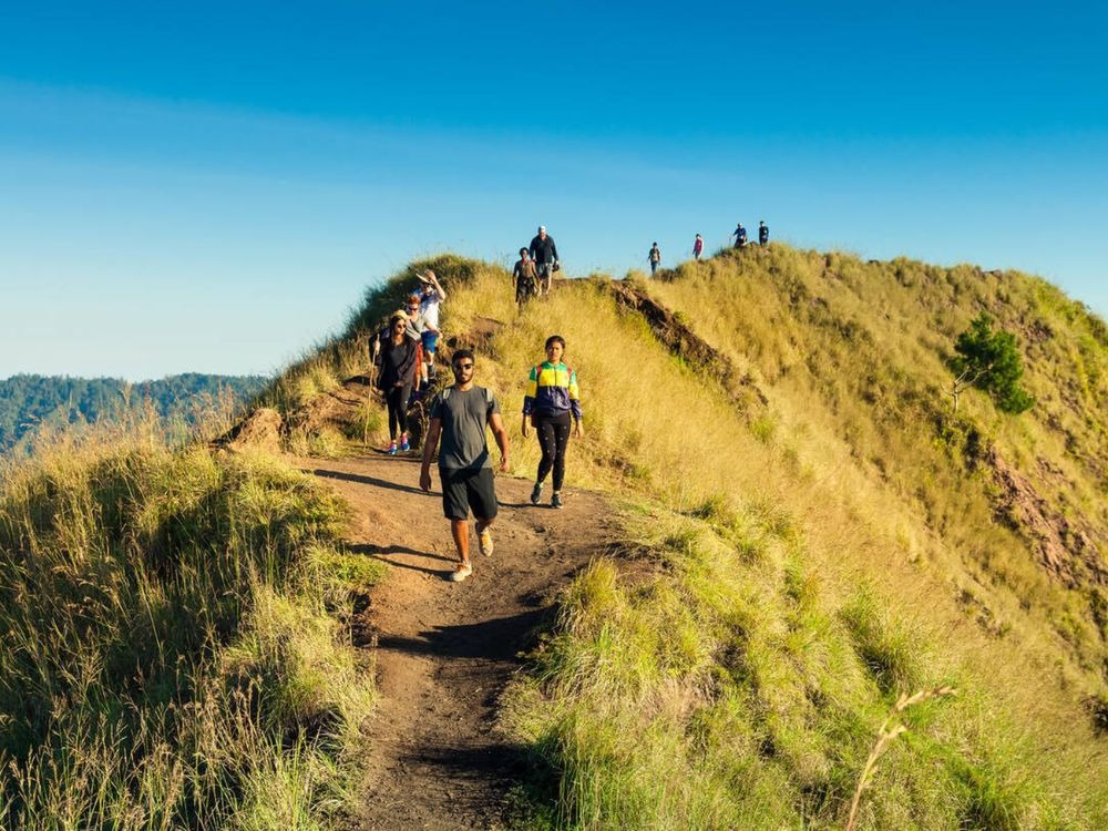 Trekking path on Mount Batur showing volcanic sand and morning sky.
